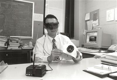 Liang Liu demonstrates construction monitoring device, 1995