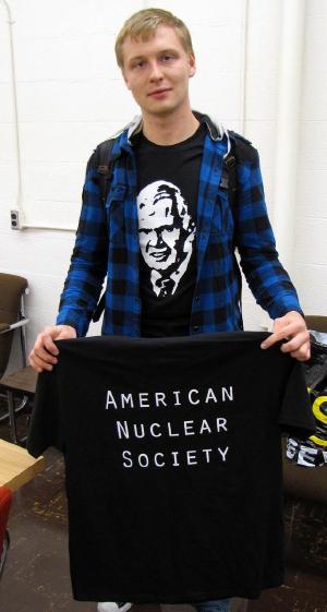 Cody Morrow, Treasurer for the American Nuclear Society student chapter at the University of Illinois, shows off the organization’s latest fashion apparel honoring NPRE Prof. Roy Axford.