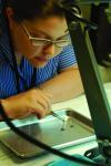 PhD student Carolyn Tomchik working with a specimen.