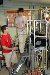 NPRE graduate students Peter Fiflis, left, and Wenyu Xu working in Prof. David Ruzic