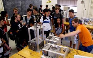 Senior Peter Mouche shows NPRE 100 students how to determine the half life of a radioactive source.