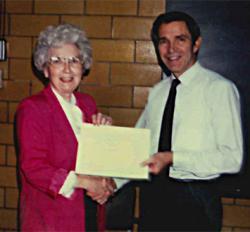 Former NPRE Department Head Barclay Jones presenting Catherine Pritchard a certificate commemorating 20 years of service to the university.