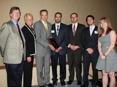 A student team optimizing lithography in computer chip processing won the inaugural Daniel F. Hang Outstanding Student Design Award in NPRE, as well as an ANS Student Conference Best Paper Award. From left are NPRE Department Head Jim Stubbins; daughter-in-law and son of the late Prof. Dan Hang, Deb and Bill Hang; and the student team, Shane Keniley, Pawel Piotrowicz, Gianluca Panici, and Amanda Lietz.  