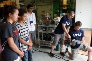 NPRE students demonstrate a railgun they have built in the Center for Plasma Material Interactions.