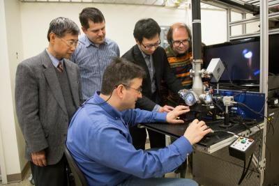 From left to right, Peter Liaw from University of Tennessee, Knoxville; Mikhail Feygenson and Louis Santodonato (seated) from ORNL; Yang Zhang from the University of Illinois at Urbana-Champaign; and Joerg Neuefeind from ORNL align a sample in the sample levitator, which was used in their experiment to study high entropy alloys. Image credit: Genevieve Martin/ORNL 
