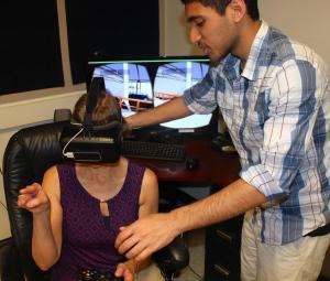 NPRE student Justin Joseph shows visitor Jill McVey how to use the Oculus Rift.