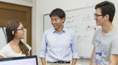 Associate Prof. Ling-Jian Meng, middle, working with his group members.