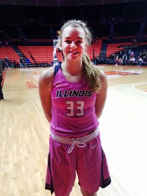 Meagan McNicholas, a freshman in NPRE, shown here following Illinois' breast cancer awareness game, has had the opportunity to continue her athletic career as a walk-on for the Illini women's basketball team.