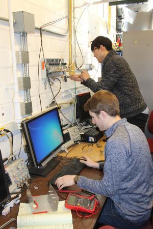 Andrew Shown and Tag Choi, working in the Center for Plasma-Material Interactions. 