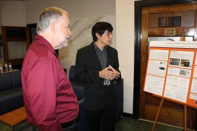 Brad Radl, a member of the NPRE Constituent Alumni and Industry Advisory Board, left, views a research poster prepared by NPRE senior Salvador Rosas. Rosas was a member of the team that won the 2018 Daniel F. Hang Outstanding Senior Design Award.