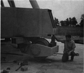Two 1700-pound wheels like this one were built in the Vermilion River Observatory shop. They permit moving the telescope, as part of a radio interferometer, to new observing positions. The jack raises the telescope off of the concrete piers on which it rests during observing sessions.