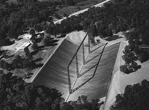Aerial view of the 400-ft telescope. The full-size 1957 sedan parked at the far end of the reflector gives scale.