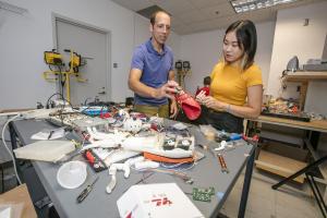 AE Associate Prof. Tim Bretl and his student, Kyung Yun Choi, examine her prosthetic robotic hand project.