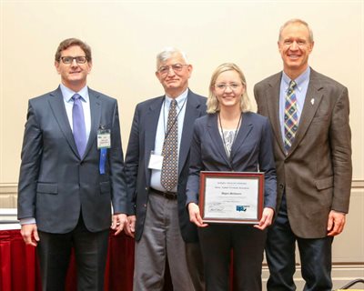 Megan McGovern, receiving the Student Research Award at the Special Joint Conference between the North Central Hot Mix Asphalt Conference and the Annual Illinois Bituminous Paving Conference with (left to right) Vice-President of Iroquois Paving in Watseka and Illinois Asphalt Pavement Association President John Lynch, Professor Marshall Thompson from the CEE department, and Governor Bruce Rauner.