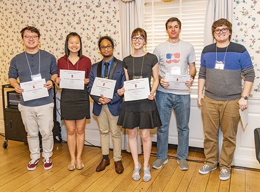 group of students holding award certificates