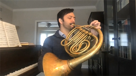 Illinois Physics Professor Yoni Kahn plays a musical composition he wrote in 2006 on his French horn during the festival. Kahn told festival goers that the acts of thinking about physics problems and writing musical pieces have a beautiful symmetry.