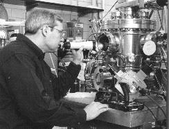 Professor Dale Van Harlingen monitors the growth of high-temperature superconductor films in a pulsed laser ablation chamber