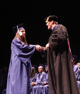 A Chemical Engineering graduate accepts her diploma from Department Head and Professor Paul J. A. Kenis.