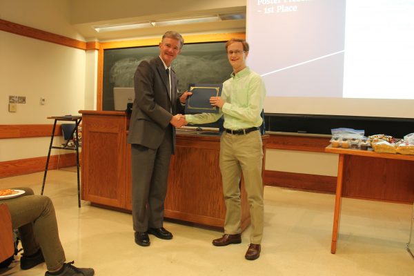 Prof. Seebauer awards first place to Charles Young for the poster competition.