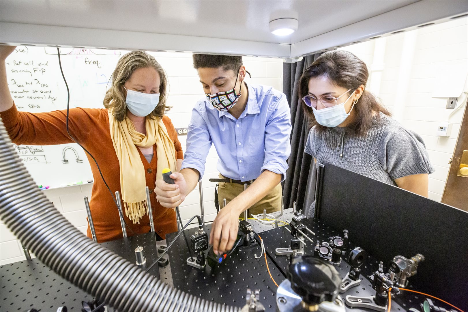 From left: Elizabeth Goldschmidt, graduate student Donny Pearson and postdoctoral fellow Safura Sharifi work on an experimental setup in Goldschmidt&rsquo;s lab at UIUC. Photo: L. Brian Stauffer, UIUC