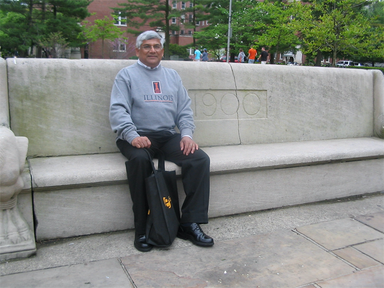 Sanak Mishra poses with the senior bench, which was originally located by University Hall and now sits ourside the Illini Union. The bench was donated by the class of 1900.