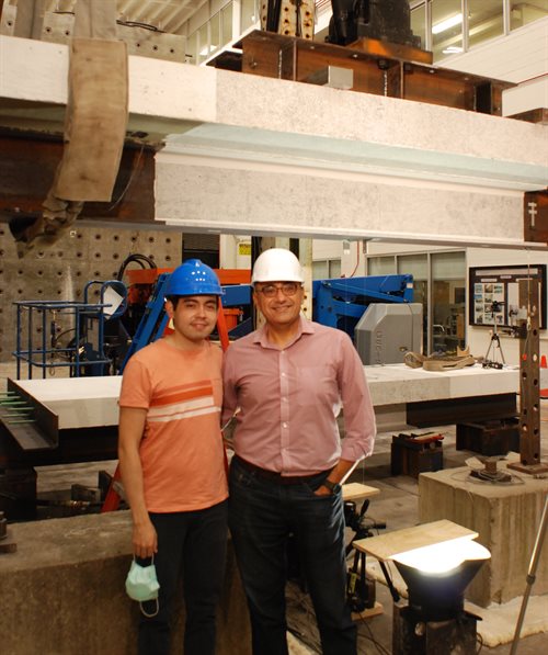 UIUC CEE doctoral student Ernesto Alfredo Perez Claros and CEE professor and Excellence Faculty Fellow Bassem Andrawes, from left, pose in UIUC&rsquo;s Newmark Structural Engineering Laboratory. Zige Zhang, a CEE master&rsquo;s graduate, also assisted the research efforts.