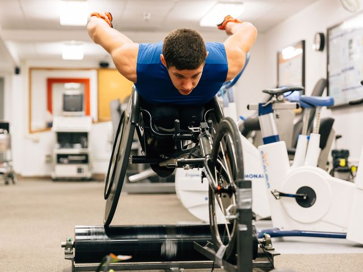 Person in wheelchair in a rehabilitation lab.