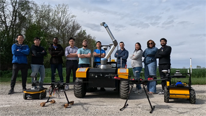 CACMS Team posing in front of robots